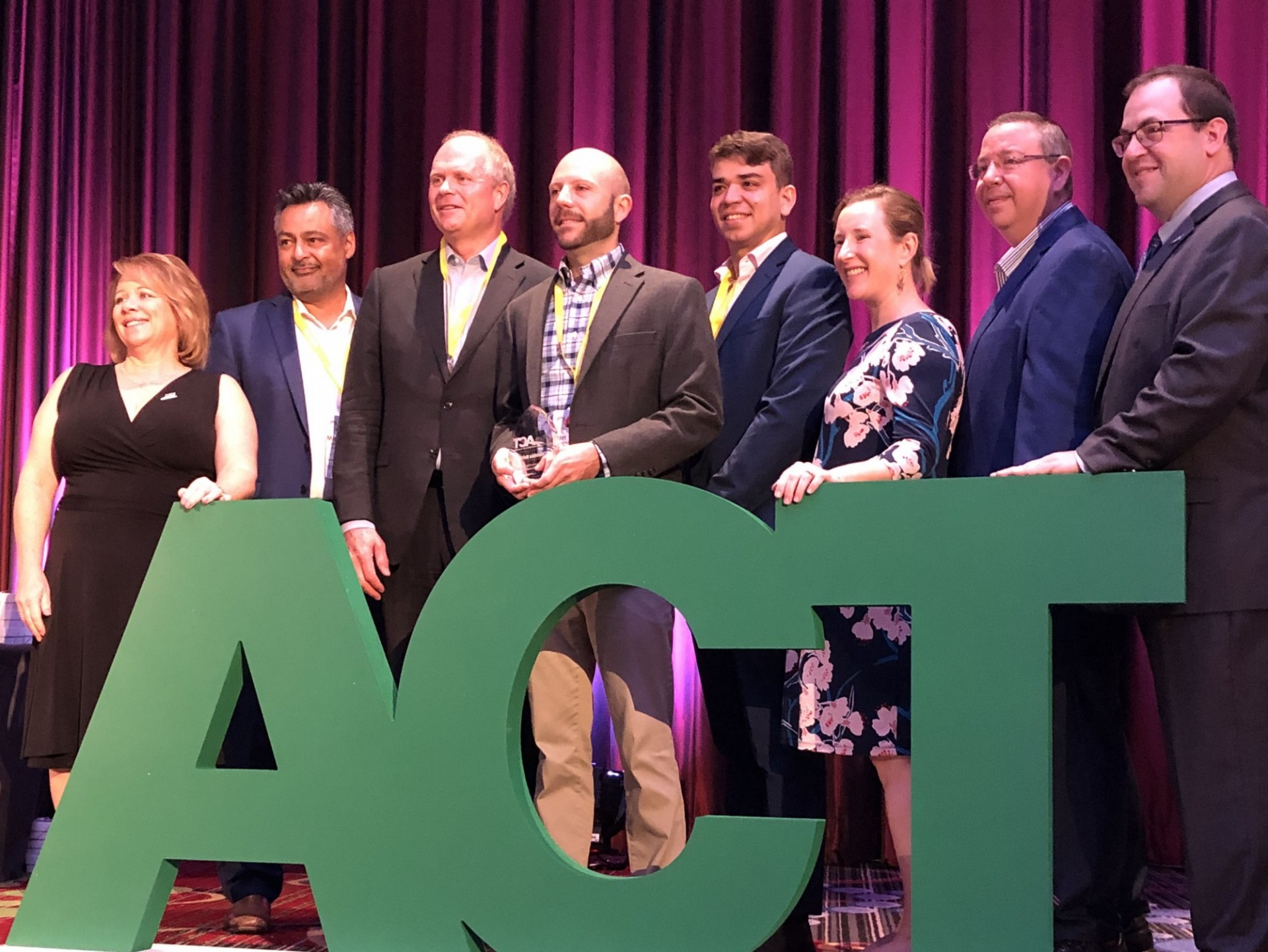 Columbia University representatives from the Transportation Office and the Office of Sustainability accept the award from ACT at the International Conference on August 7, 2019.
