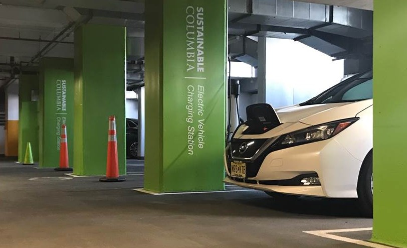 electric vehicle charger with green sustainable columbia pillars inside a parking garage